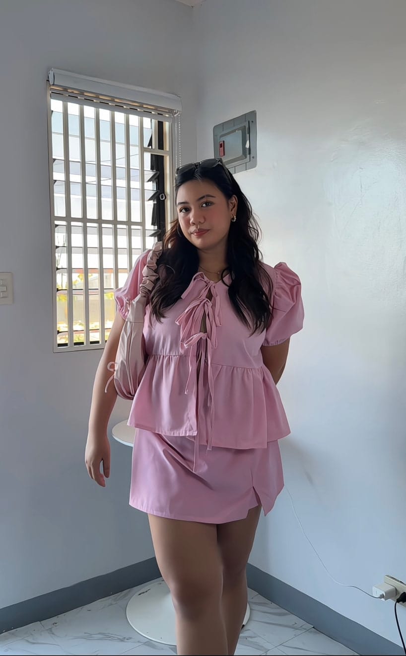 Aliyha in a pink two-piece set, photographed at home